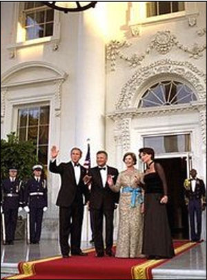 Bush and Mrs. Bush wave to photographers with President Kwasniewski and Mrs. Kwasniewska
