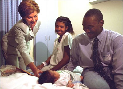 Laura Bush visits with parents Ronnie and Chakeiva Collins, a couple from Plant City, Florida and their 2-day-old son at Tampa General Hospital on Tuesday, October 1, 2002. Mrs. Bush presented the new parents a copy of the Healthy Start, Grow Smart magazine series that provides parents with critical information about the early development, health, nutrition and safety needs of babies and toddlers.