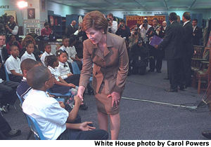 First Lady Laura Bush shakes hands with a student at the Patricia R. Harris Educational Center. White House photo by Carol Powers.