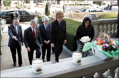 Laura Bush approaches a candle-lit memorial honoring the victims of the recent tsunami at the Embassy of Indonesia during a visit with President George W. Bush and former Presidents Bush and Clinton in Washington, D.C., Monday, Jan. 3, 2005.