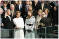 With his left hand resting on a family Bible, President George W. Bush takes the oath of office to serve a second term as 43rd President of the United States during a ceremony at the U.S. Capitol, Thursday, Jan. 20, 2005. Laura Bush, Barbara Bush, and Jenna Bush listen as Chief Justice William H. Rehnquist administers the oath.