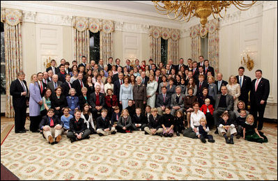 President George W. Bush, Laura Bush, former President George H. W. Bush, and former First Lady Barbara Bush pose for a portrait with members of their extended family in the East Room of the White House, Wednesday, Jan. 19, 2005. 