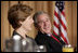 President George W. Bush and Laura Bush laugh during the National Prayer Breakfast in Washington, D.C., Thursday, Feb. 3, 2005.