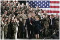 During a Feb. 23, 2005, visit to Wiesbaden Army Air Field in Wiesbaden, Germany, President George W. Bush and Laura Bush are welcomed by applause from U.S. troops.