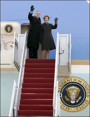 President George W. Bush and Laura Bush wave from the Air Force One stairs en route Brussels, Belgium, Sunday, Feb. 20, 2005. President Bush and Laura Bush flew from Andrews Air Force Base in Maryland to Belgium, beginning a five-day trip to Belgium, Germany and Slovakia.
