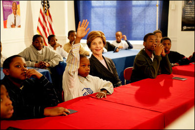 Laura Bush listens as boys participating in the Passport to Manhood program share ideas about respect and love during a visit to the Germantown Boys and Girls Club Tuesday, Feb. 3, 2005 in Philadelphia. Passport to Manhood promotes and teaches responsibility through a series of male club members ages 11-14.