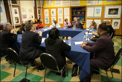 The President and Mrs. Bush sit among children of prisoners, their mentors and administrators Friday, April 1, 2005, during a roundtable discussion at Paul Public Charter School in Washington DC. The president met with the kids and others as part of his Helping America's Youth initiative.