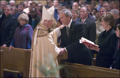 Cardinal Theodore McCarrick greets President George W. Bush and Mrs. Laura Bush after mass at the Cathedral of Saint Matthew the Apostle in Washington, DC on Saturday, April 2, 2005 in remembrance of Pope John Paul II.