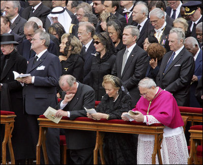 President George W. Bush and Laura Bush stand amidst mourners at funeral services Friday, April 8, 2005, for the late Pope John Paul II in St. Peter's Square. The funeral is being called the largest of its kind in modern history.