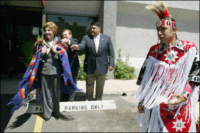 Laura Bush wears a traditional Native American wrap as she watches a musical performance before touring the Native American Community Health Center in Phoenix, Ariz., April 26, 2005.