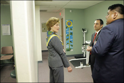Dr. Babak Nayeri, Medical Director of the Native American Community Health Center, and Marcus Harrison, CEO of the Native American Community Health Center, give Laura Bush a tour of the Native American Community Health Center in Phoenix, Ariz., April 26, 2005.