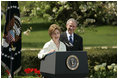 President George W. Bush looks on as he's introduced by First Lady Laura Bush Wednesday, April 20, 2005, to honor the 2005 National Teacher of the Year during ceremonies in the Rose Garden. Jason Kamras, a math teacher of eight years at John Philip Sousa Middle School in Washington, D.C., received the honors.