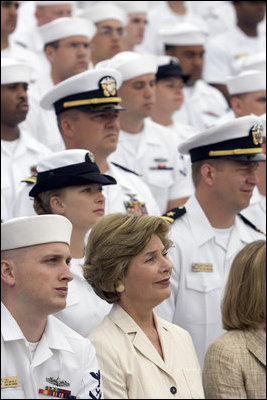 Laura Bush listens to President George W. Bush speak during a ceremony to commemorate the 60th anniversary of V-J Day at the Naval Air Station in San Diego, Calif., August 30, 2005.