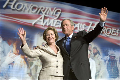 President George W. Bush and Laura Bush wave to the crowd of military families, Wednesday, Aug. 24, 2005 at the Idaho Center Arena in Nampa, Idaho, following the President's speech honoring the service of National Guard and Reserve forces serving in Afghanistan and Iraq.