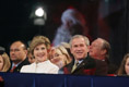 President George W. Bush and Laura Bush watch the holiday entertainment, Thursday evening, Dec. 1, 2005, during the Pageant of Peace and the lighting of the National Christmas Tree on the Ellipse in Washington.