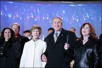 President George W. Bush and Laura Bush join holiday entertainers Thursday evening, Dec. 1, 2005, on stage during the Pageant of Peace and lighting of the National Christmas Tree festivities on the Ellipse in Washington.