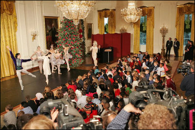 Sitting with children, President and Laura Bush watch the American Ballet Company perform part of the Holiday classic, "The Nutcracker," during the Children's Holiday Reception in the East Room Monday, Dec. 5, 2005.