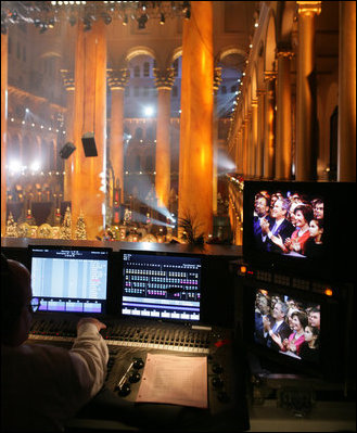 The President and Mrs. Bush are seen on a television monitor Sunday, Dec. 11, 2005, as they enjoyed the festivities during the 24th Annual Christmas in Washington as it was videotaped at the National Building Museum.