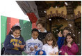 Laura Bush and children from New Orleans neighborhoods react to a downpour of fake snow flakes, Monday Dec. 12, 2005 at the Celebration Church in Metairie, La., during a Toys for Tots event.