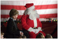 Laura Bush talks with a group of children as she visits the Naval and Marine Corps Reserve Center in Gulfport, Miss., Monday, Dec. 12, 2005, where she showed them White House holiday video featuring the Bush's dogs "Barney and Miss Beazley."