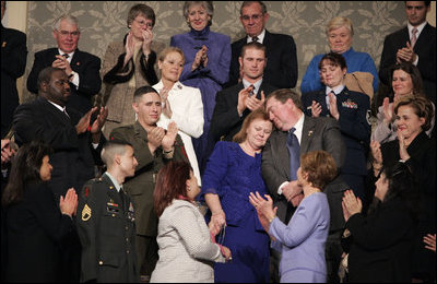 During the State of the Union Address Wednesday, Feb. 2, 2005, Janet and William Norwood, center, comfort each other as President Bush talks about their son, Marine Corps Sergeant Byron Norwood of Pflugerville, Texas, who died during the assault on Fallujah. "Ladies and gentlemen, with grateful hearts, we honor freedom's defenders, and our military families, represented here this evening by Sergeant Norwood's mom and dad, Janet and Bill Norwood," President Bush said during his speech at the U.S. Capitol.