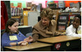 Mrs. Bush greets Hainerberg Elementary School student Hailey Cook during her visit with fourth and fifth graders Tuesday, Feb. 22, 2005 in Wiesbaden, Germany.