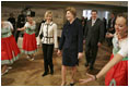 Laura Bush watches dancers during a Wednesday, Feb. 23, 2005, lunch hosted by Chancellor Gerhard Schroeder, behind, and Mrs. Schroeder-Koepf, left, at the Electoral Palace in Mainz, Germany.