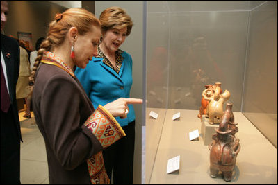 Elaine Karp de Toledo, First Lady of Peru, explains artifacts on display to Laura Bush during a visit to view the exhibit "Peru: Indigenous and Viceregal," at the National Geographic Society Friday, Feb. 25, 2005 in Washington, D.C. Also present is John Fahey, Jr., President and CEO of National Geographic Society.