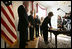 Laura Bush signs a condolence book for the victims of the recent tsunami during a visit to the Embassy of Sri Lanka in Washington, D.C., Monday, Jan. 3, 2005. Also signing to express their condolences are President George W. Bush and former Presidents Clinton and Bush.