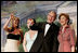 With his twin daughters Jenna, left, and Barbara by his side, President George W. Bush points out members of the audience to Laura Bush during a Black Tie and Boots Inaugural Ball in Washington, D.C., Wednesday, Jan. 19, 2005.