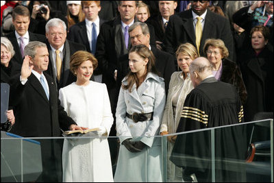 With his left hand resting on a family Bible, President George W. Bush takes the oath of office to serve a second term as 43rd President of the United States during a ceremony at the U.S. Capitol, Thursday, Jan. 20, 2005. Laura Bush, Barbara Bush, and Jenna Bush listen as Chief Justice William H. Rehnquist administers the oath.