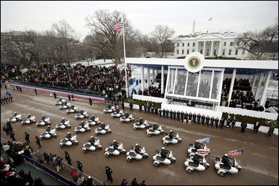 A procession of motorcycles leads the Inaugural Parade down Pennsylvania Avenue past the President's reviewing stand in front of the White House, Jan. 20, 2005. President George W. Bush and Laura Bush traveled with the parade after a swearing-in ceremony for the President at the U.S. Capitol.