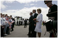 President George W. Bush and Laura Bush are greeted by ceremony and cheers upon their arrival at Glasgow Prestwick International Airport in Scotland July 6, 2005.