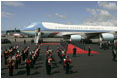 As President George W. Bush and Laura Bush disembarks Air Force One, a band is poised for their arrival at Glasgow's Prestiwick Airport, July 6, 2005.