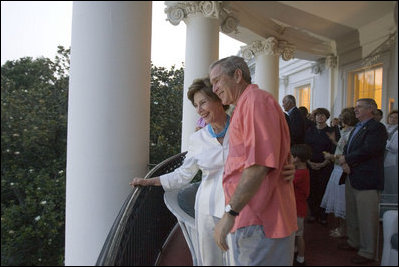 On July 4, 2005, President and Mrs. Bush listen as a South Lawn crowd sings "Happy Birthday" at the White House in celebration of the President's upcoming birthday on July 6.