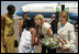 Laura Bush and daughter Jenna Bush are greeted at an arrival ceremony Thursday, July 14, 2005 at Kigali International Airport in Kigali, Rwanda.