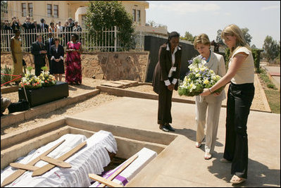 Laura Bush and daughter Jenna lay a wreath Thursday, July 14, 2005 at the Kigali Memorial Center-Gisozi Genocide Memorial in Kigali, Rwanda.