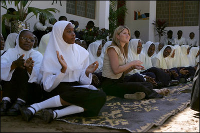 Jenna Bush sits with students at the Kiembesamaki Teacher Training School in Zanzibar, Tanzania, Wednesday, July 14, 2005.