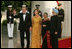 President George W. Bush and Laura Bush welcome India Prime Minister Dr. Manmohan Singh and Mrs. Gursharan Kaur, as they arrive for the official dinner at the White House, Monday, July 18, 2005.