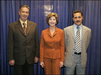 Laura Bush visits with Talib Aziz M. Zaini, Minister of Youth and Sports for Iraq, left, and Abbas Kadim Ibrahim, Director General, Ministry of Youth and Sports for Iraq, at the National Youth Summit in Washington, D.C., Friday, July 29, 2005. The Iraqi officials attended the summit to increase their understanding of youth development.