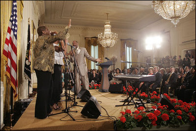 President George W. Bush and Laura Bush listen to performers during the White House reception honoring June as Black Music Month in the East Room Monday, June 6, 2005. Gospel artists Smokie Norful, Mary Mary and Reverend Donnie McClurkin performed during the ceremony.