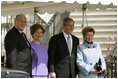 President George W. Bush and Laura Bush greet Their Majesties King Harald and Queen Sonja of Norway at the South Portico entrance of the White House before hosting the King and Queen for lunch Monday, March 7, 2005.