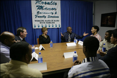 Laura Bush Secretary of Health and Human Services Mike Leavitt listen to Alphonso Pettis, Case Manager for Today's Dad's at Rosalie Manor Community and Family Services center in Milwaukee, Wis, Tuesday, March 8, 2005. Mr. Pettis is explaining in detail the pride he feels regarding the achievements of the young men sitting at the table, who, as teen fathers, have finished high school and found jobs.
