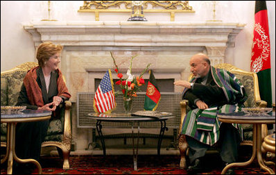 Afghan President Hamid Karzai jokes with Laura Bush during a meeting in the Presidential Palace in Kabul, Afghanistan Wednesday, March 30, 2005.