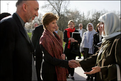 First lady Laura Bush and Margaret Spellings, Secretary of Education, center, stand with Afghan President Hamid Karzai Wednesday, March 30, 2005, after their arrival in Kabul.
