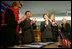 Laura Bush applauds as Secretary of Education Margaret Spellings and Afghan Minister of Education Noor Mohammas Qarqeen complete the signing of the Memorandum of Understanding for funds to build a university in Kabul, Afghanistan Wednesday, March 30, 2005.
