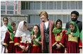Mrs. Laura Bush stands with a group of Afghan girls on hand to greet her Wednesday, March 30, 2005, upon her arrival in Kabul.