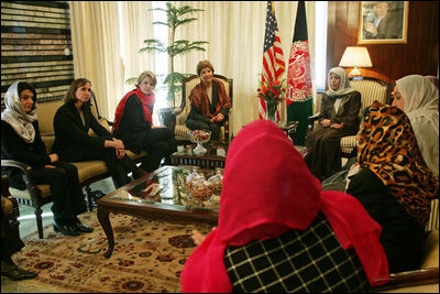 Laura Bush and Dr. Zenat Karzai, wife of President Hamid Karzai, center, join Paula Dobrianski, second from left, Under Secretary of State for Global Affairs, and Margaret Spellings, U.S. Secretary of Education, third from left, as they talk with Afghan women about issues of women's rights and education at the presidential residence in Kabul Wednesday, March 30, 2005.