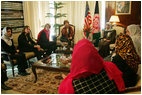 Laura Bush and Dr. Zenat Karzai, wife of President Hamid Karzai, center, join Paula Dobrianski, second from left, Under Secretary of State for Global Affairs, and Margaret Spellings, U.S. Secretary of Education, third from left, as they talk with Afghan women about issues of women's rights and education at the presidential residence in Kabul Wednesday, March 30, 2005.