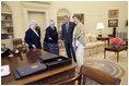 President George W. Bush and Laura Bush discuss some of the history of the Oval Office Agnes Chouteau, left, and Lorraine Stange both of Missouri Monday, May 2, 2005. The two women are recipients of the 2005 Preserve America Presidential Award.